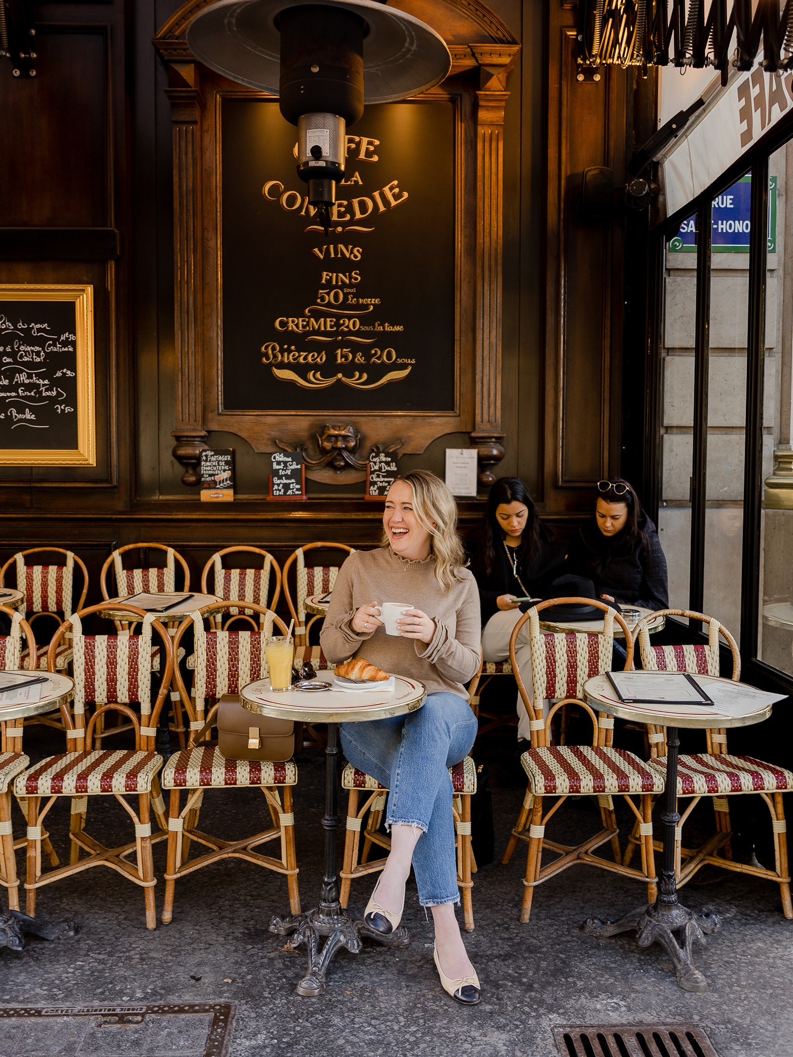 Woman at a cafe in Paris, representing the lifestyle and experience of European travel