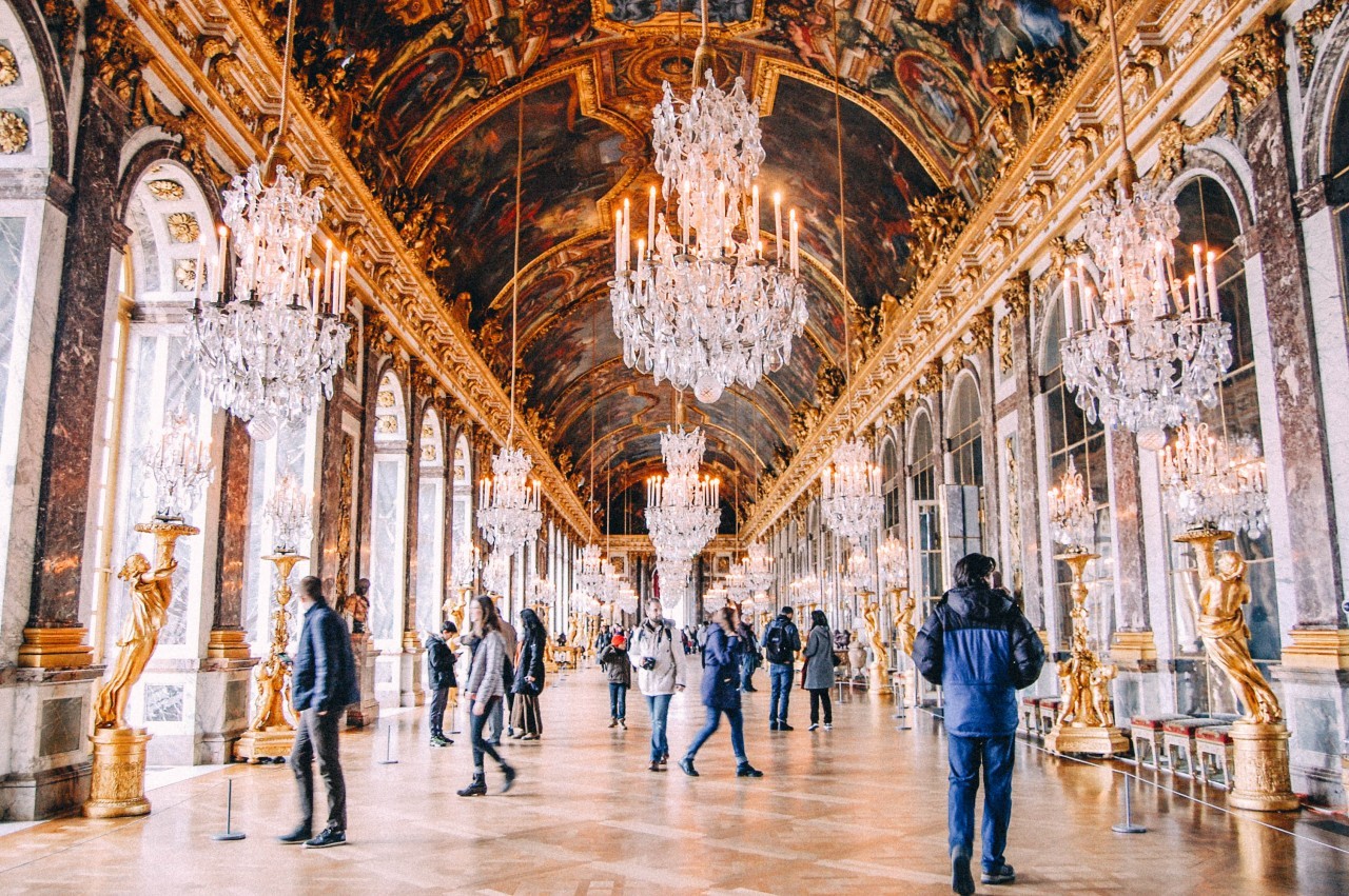 The Hall of Mirrors in the Palace of Versailles, reflecting its grandeur and ornate decorations.