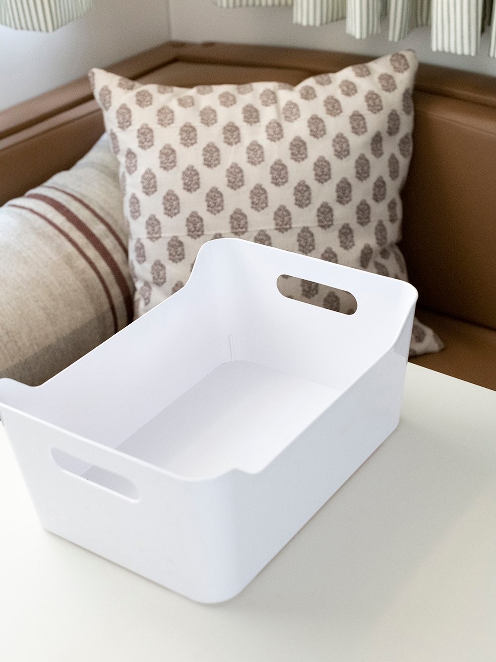 Plastic bins for dinette storage in a travel trailer