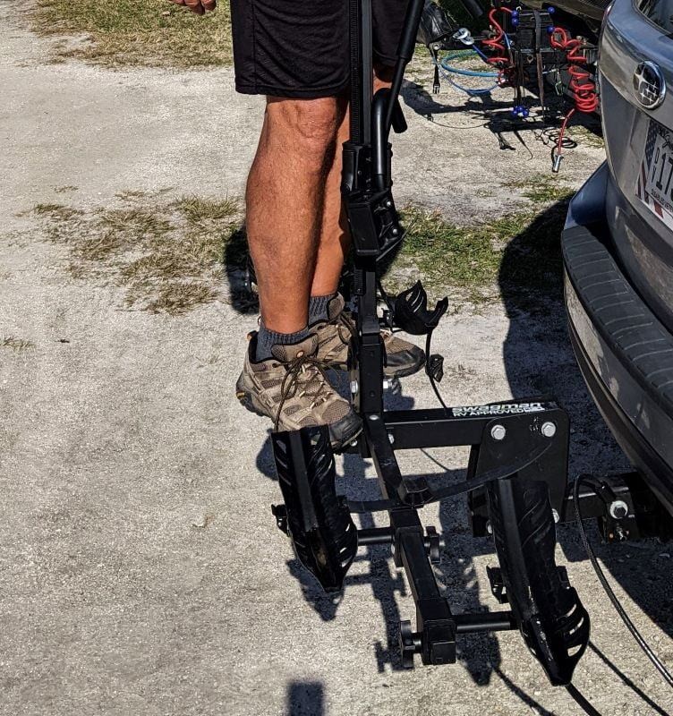 Demonstrating the strength of the Swagman RV-Approved Bike Rack by standing on it.