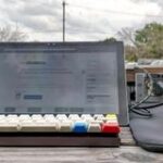 A Microsoft Surface on a table with a mechanical keyboard and a mouse