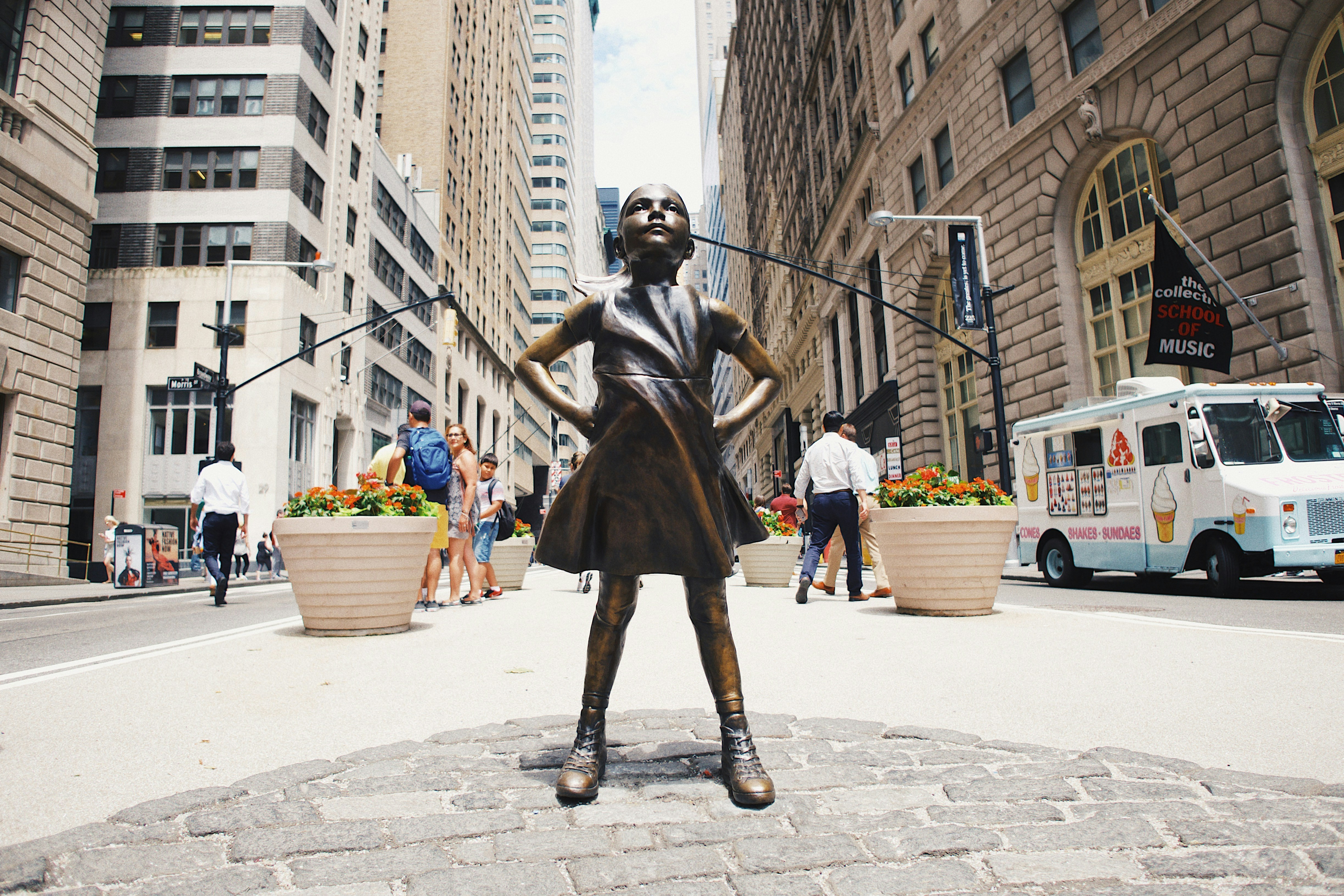 The Charging Bull sculpture on Wall Street, New York City, surrounded by tourists