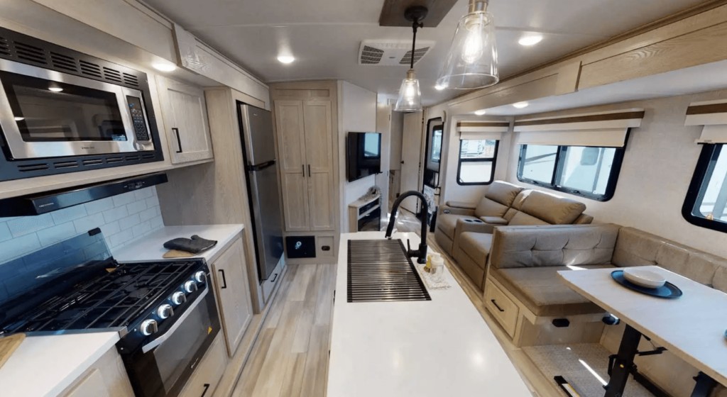 alt text: The Rockwood Signature 8336BH travel trailer, designed for large groups, features a bunk room with TV and washer dryer prep for family-friendly adventures.