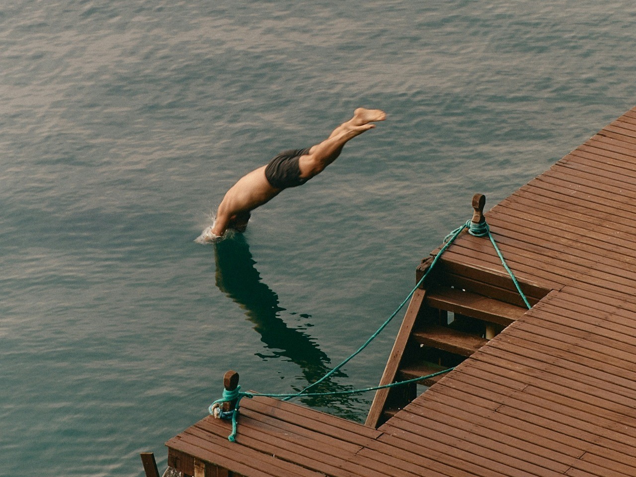 Man jumping into water in a lake