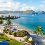 Aerial view of Sandals Grande St. Lucian resort beach and surrounding hills