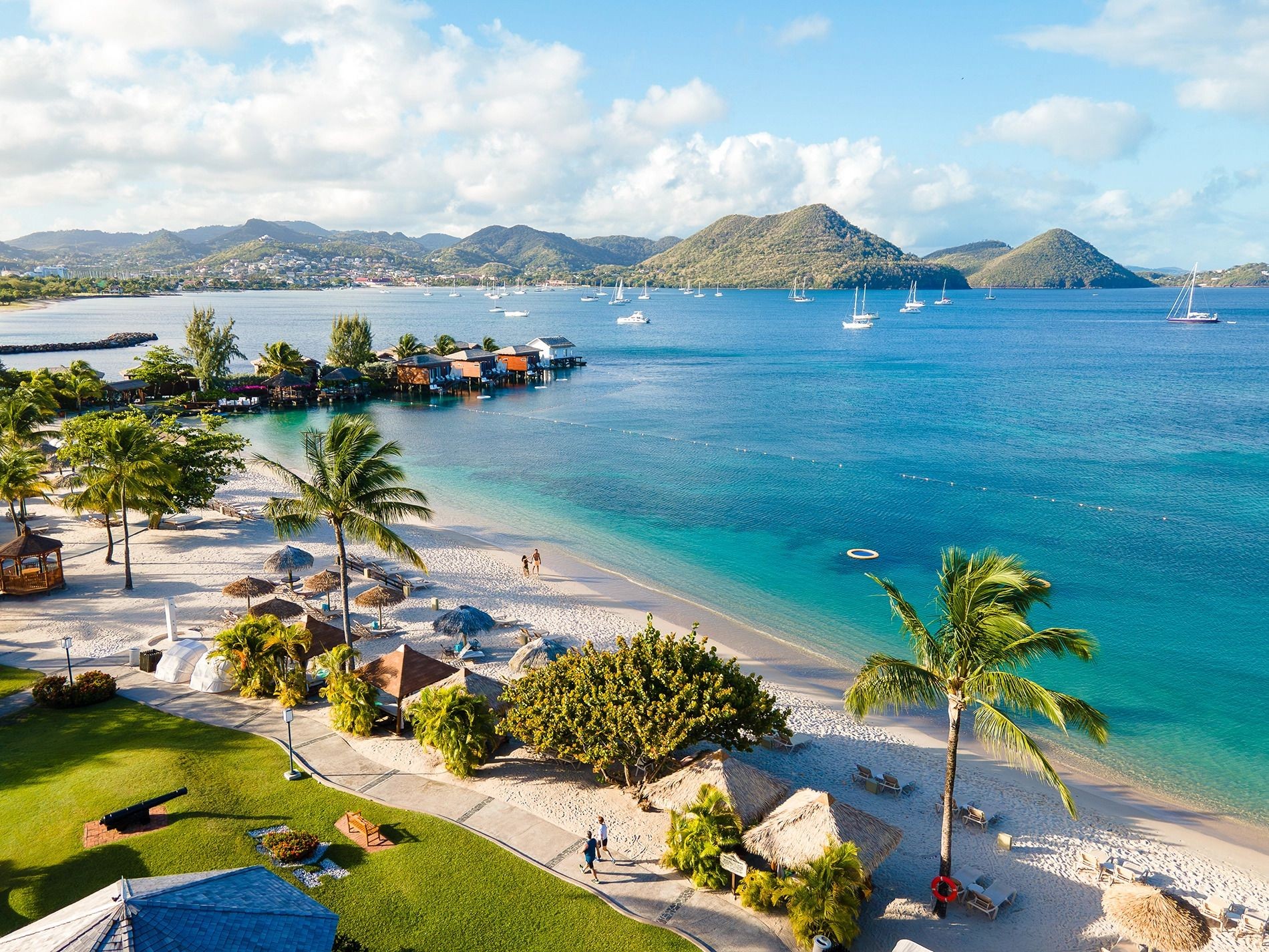 Aerial view of Sandals Grande St. Lucian resort beach and surrounding hills