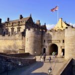 People walk into the barbican (fortified entrance) of Stirling Castle, home of Mary Queen of Scots and Robert the Bruce, Stirling, Scotland UK