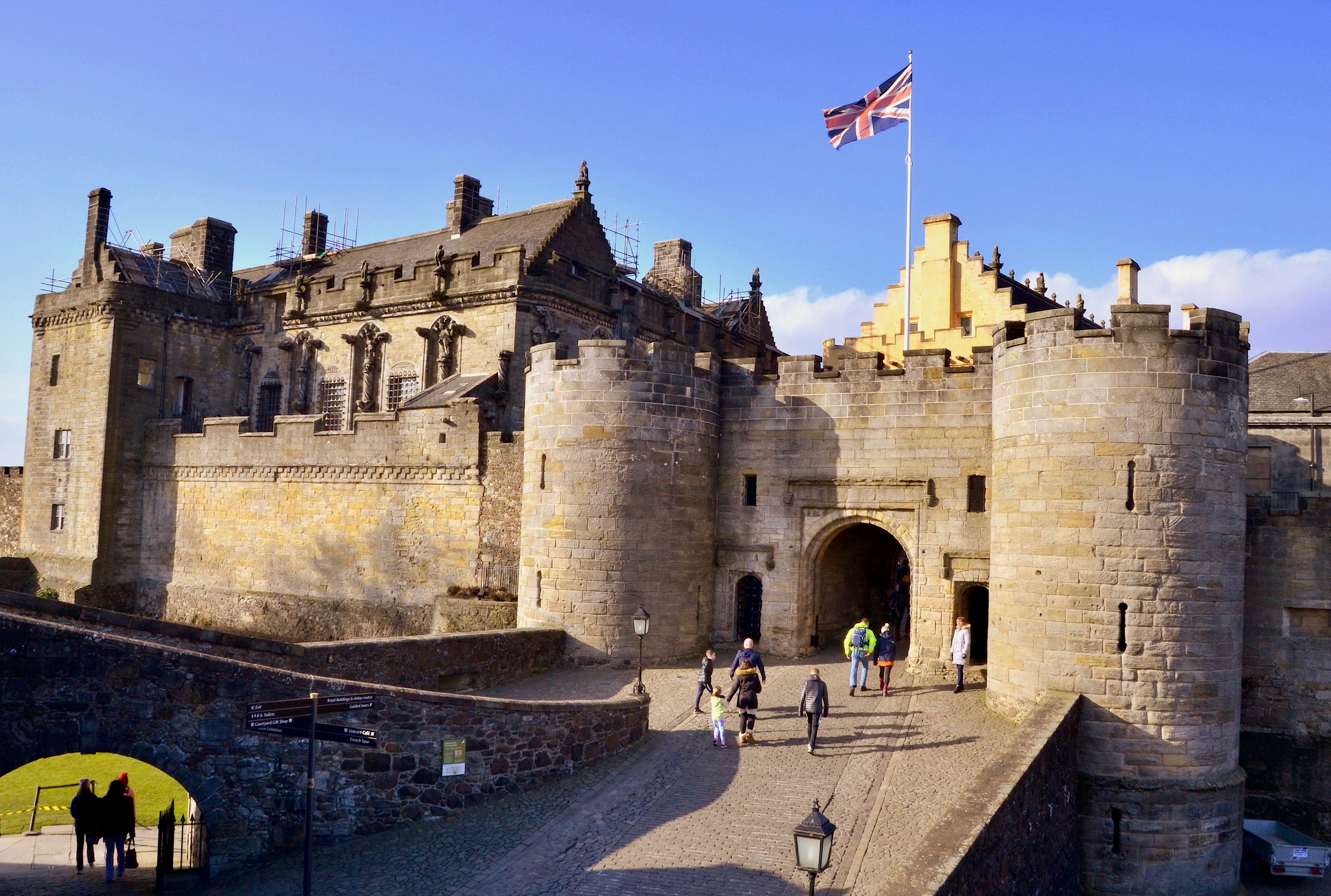 People walk into the barbican (fortified entrance) of Stirling Castle, home of Mary Queen of Scots and Robert the Bruce, Stirling, Scotland UK