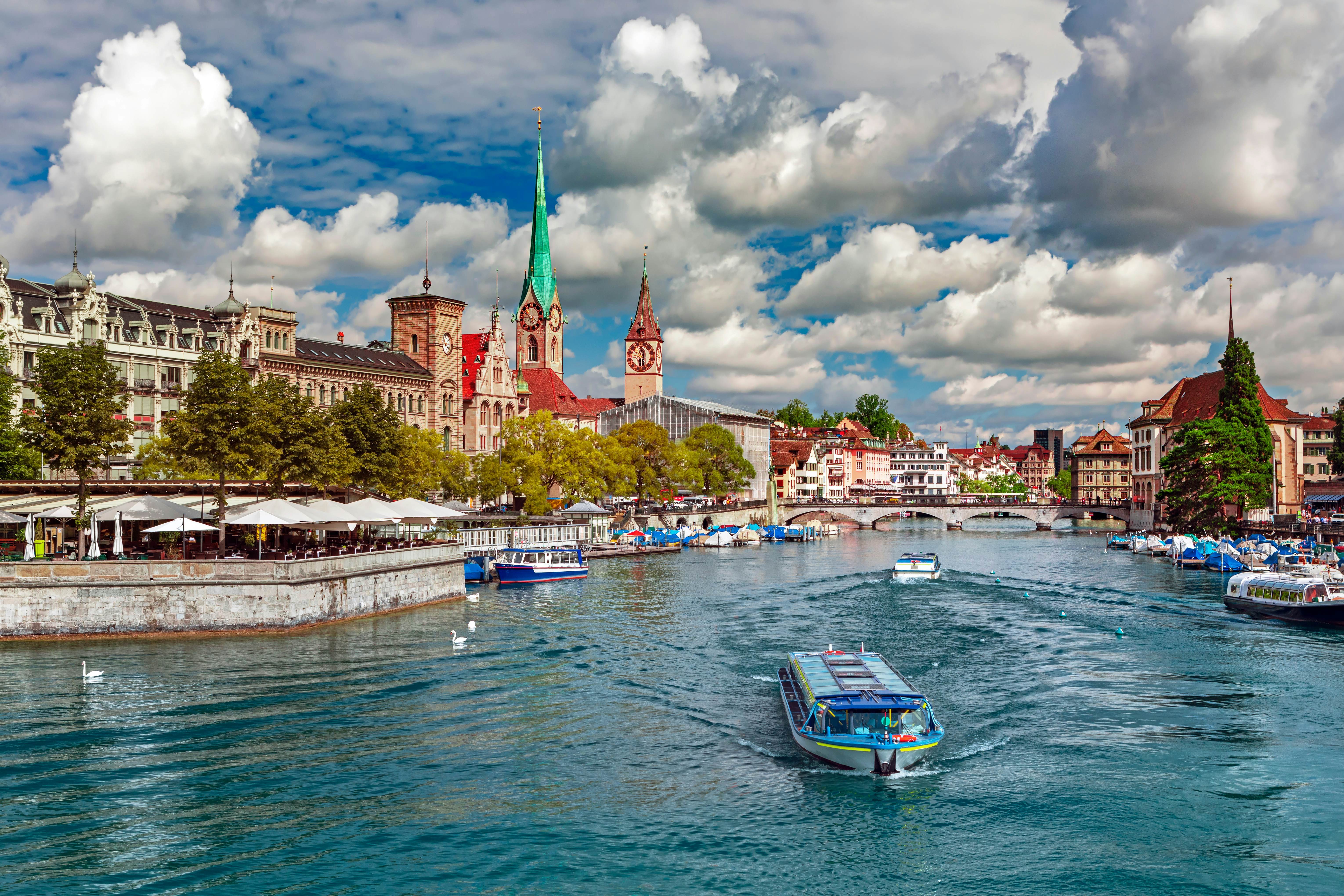 Scenic view of historic Zurich city center with the famous Fraumunster and Grossmunster churches and the Limmat River, Switzerland.