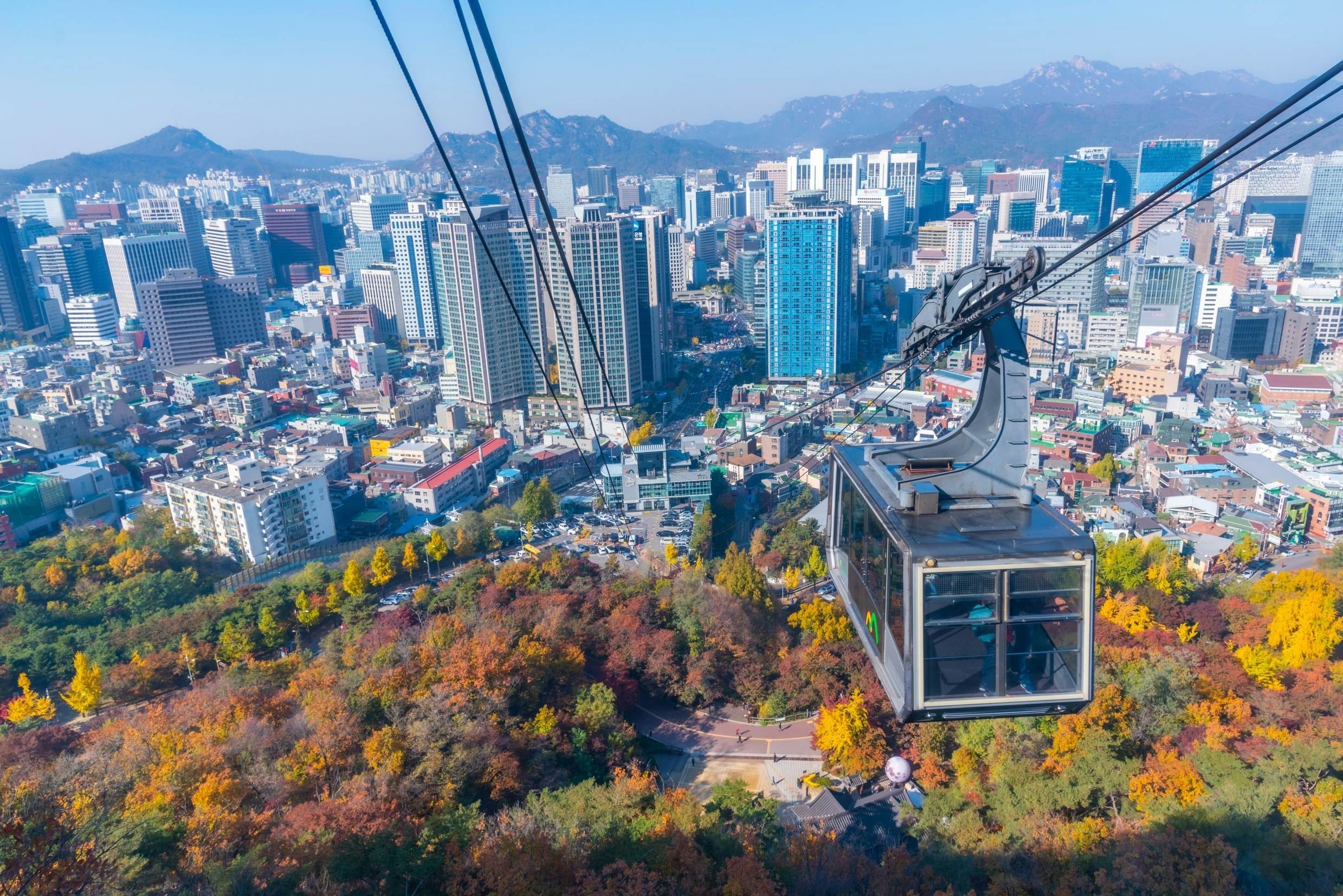 Seoul, South Korea, a modern cityscape with cable cars ascending above high-rise buildings, showcases Asia's futuristic side