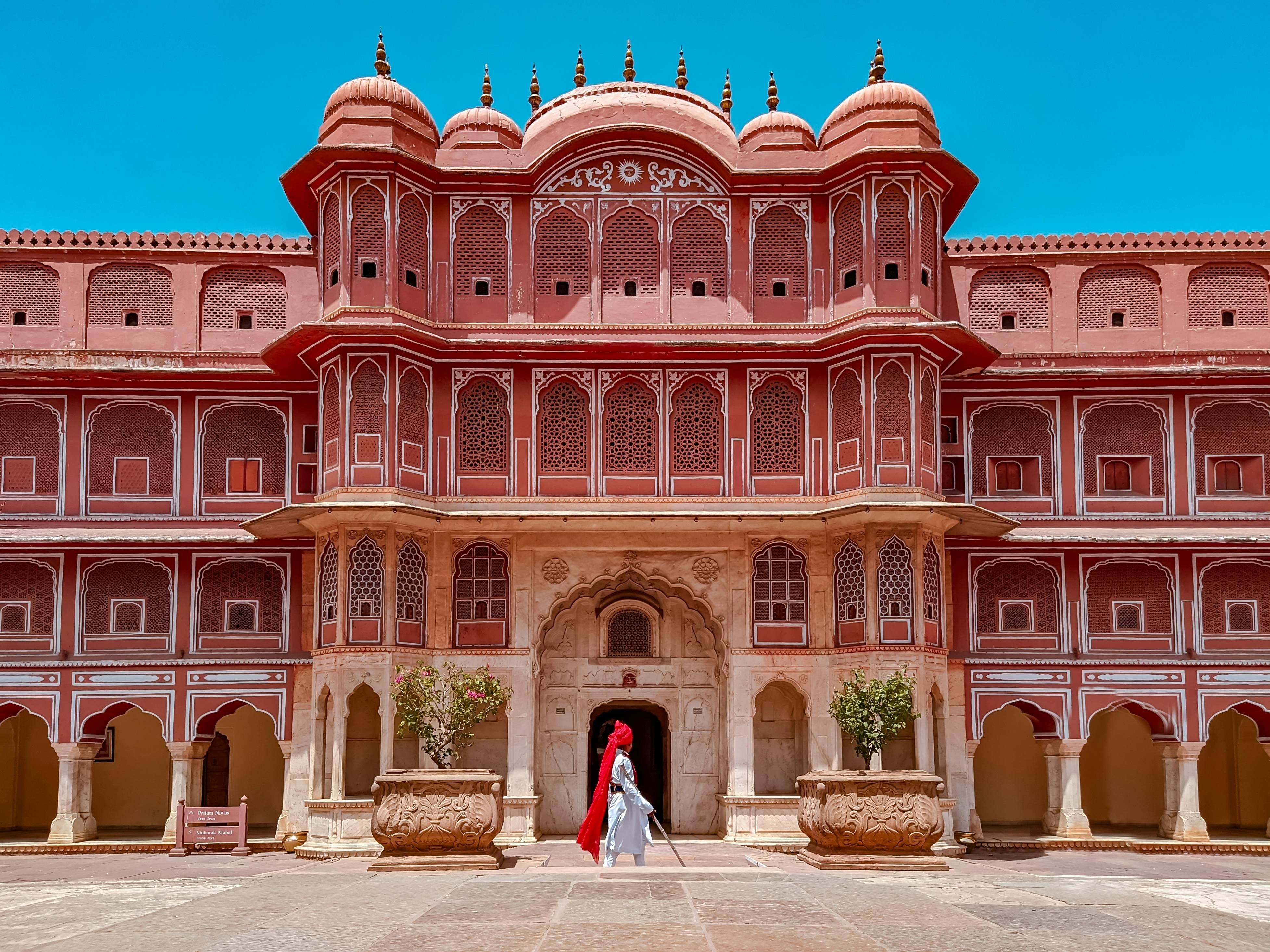 Jaipur's City Palace in India, painted in vibrant red with white accents, showcases the historic architecture of the Pink City