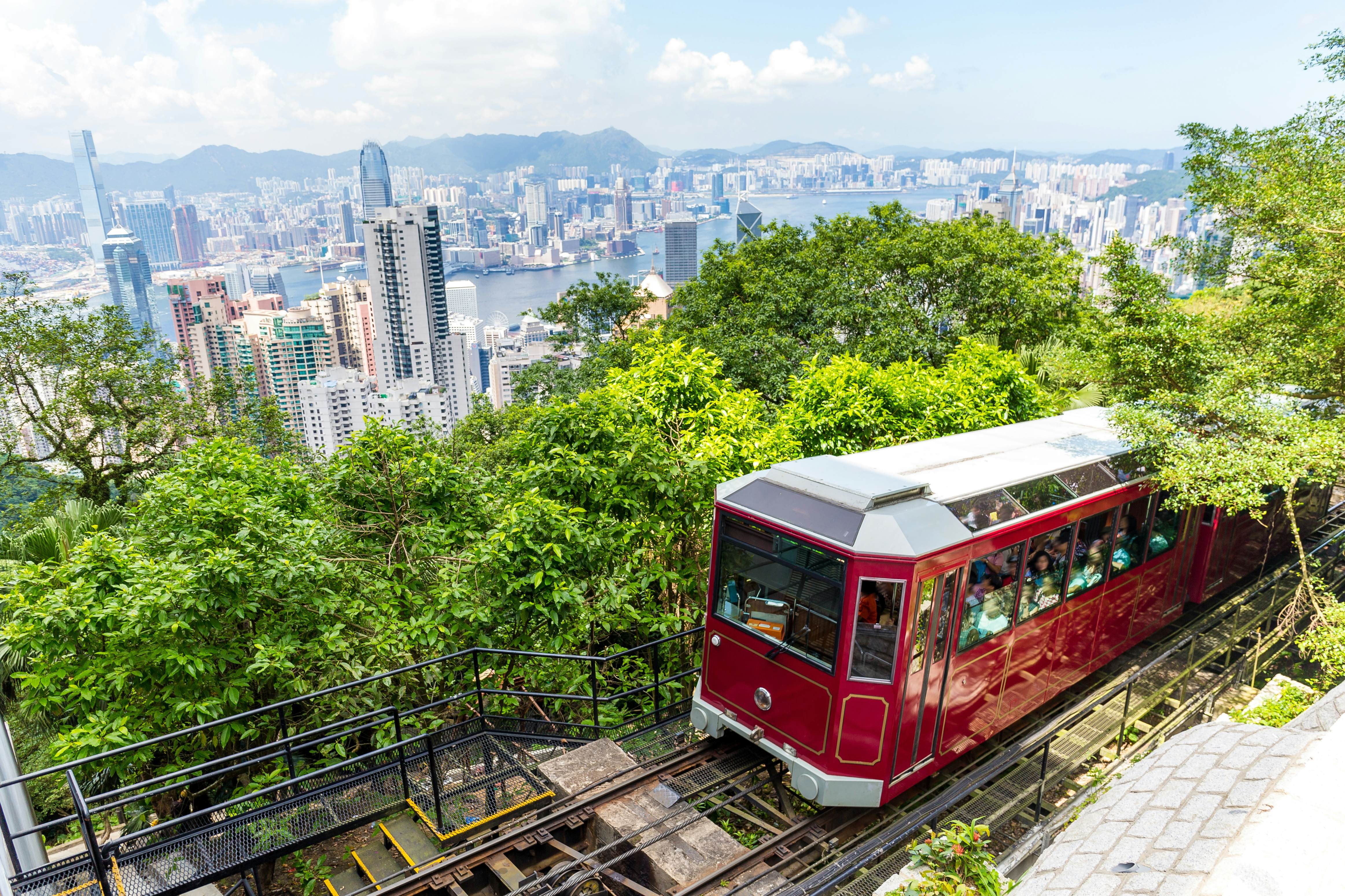 Hong Kong skyline with the Peak Tram ascending, showcasing the city's blend of urban and natural landscapes