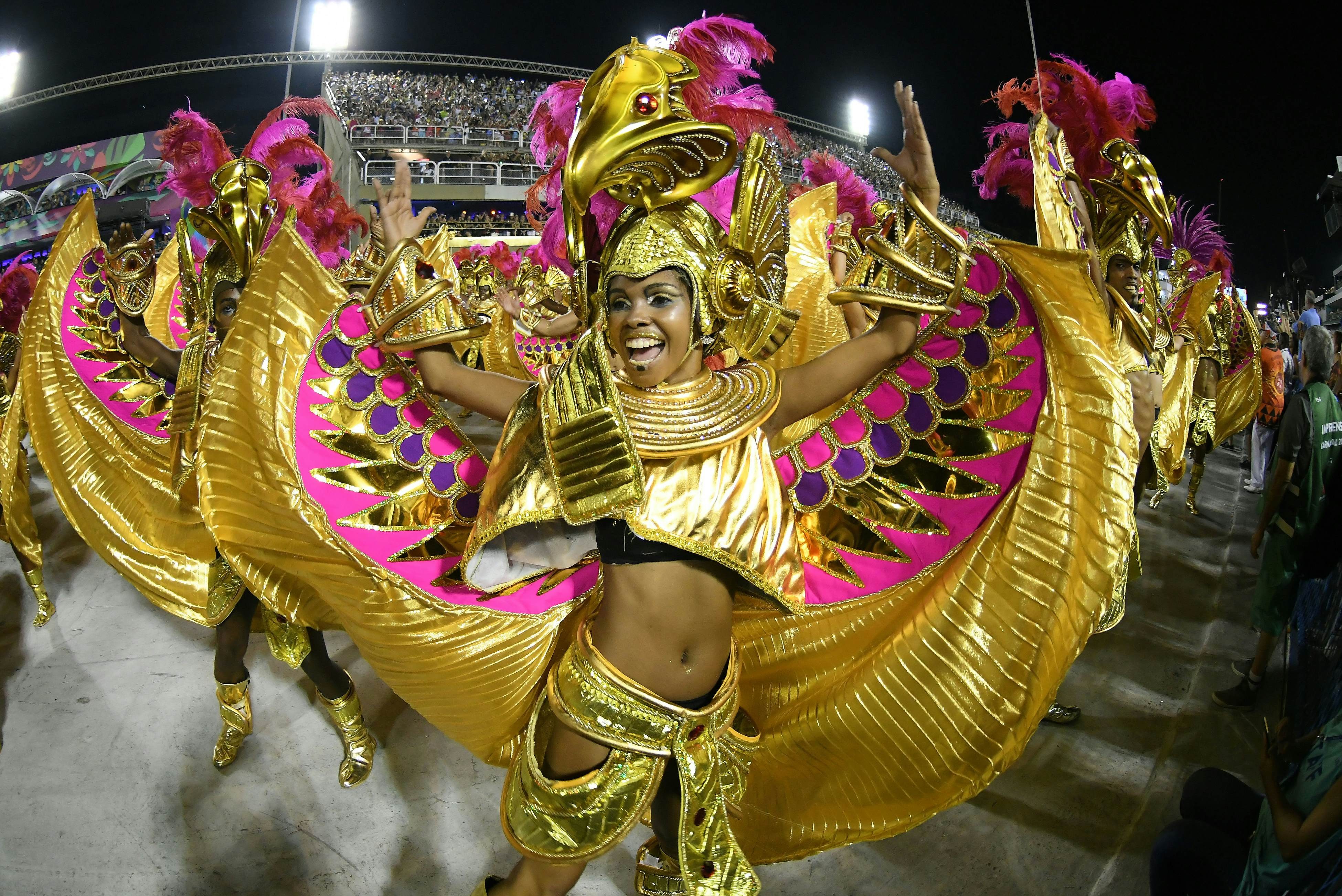 Vibrant dancers in elaborate costumes perform in the Sambadrome during the Carnival in Rio de Janeiro.