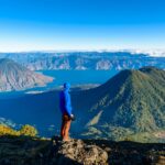 Hiker overlooking volcanic summits at Lake Atitlan