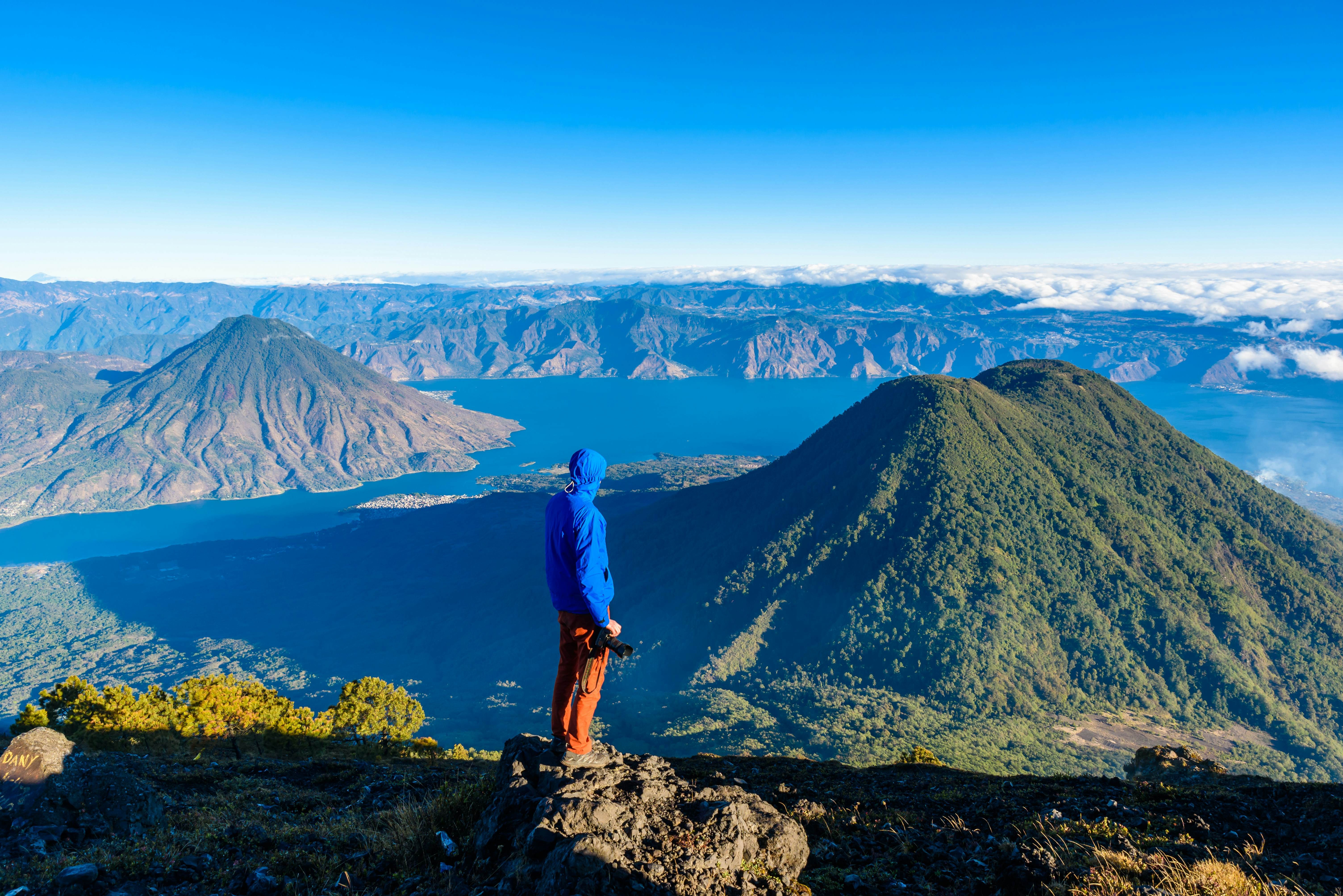 Hiker overlooking volcanic summits at Lake Atitlan