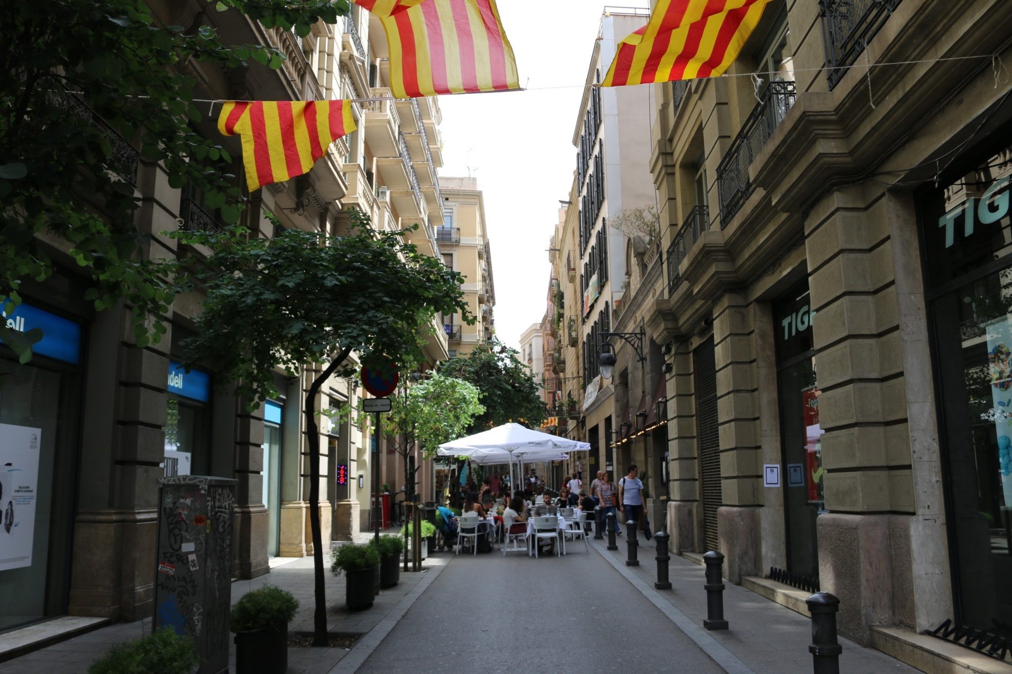 A vibrant outdoor market scene in Spain, filled with colorful produce and locals interacting, highlighting the importance of food and community in Spanish culture.