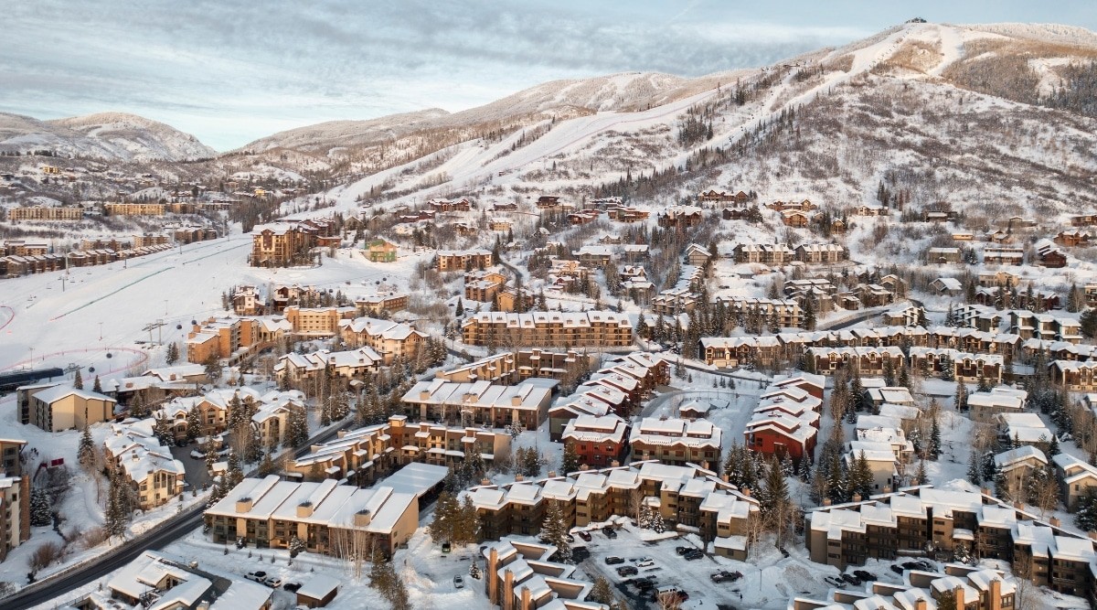 Snowy cityscape of Steamboat Springs, Colorado, showcasing snow-covered rooftops and winter conditions.