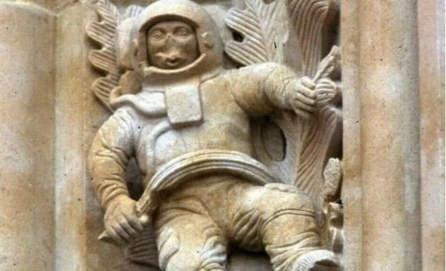 A photograph of a sculpture on a church wall from the 17th-18th century, which strikingly resembles a modern-day astronaut in a spacesuit.