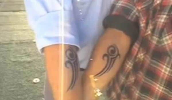 A photo showing two hands with identical tattoos, presented as evidence by a man claiming to have met his future self through time travel.