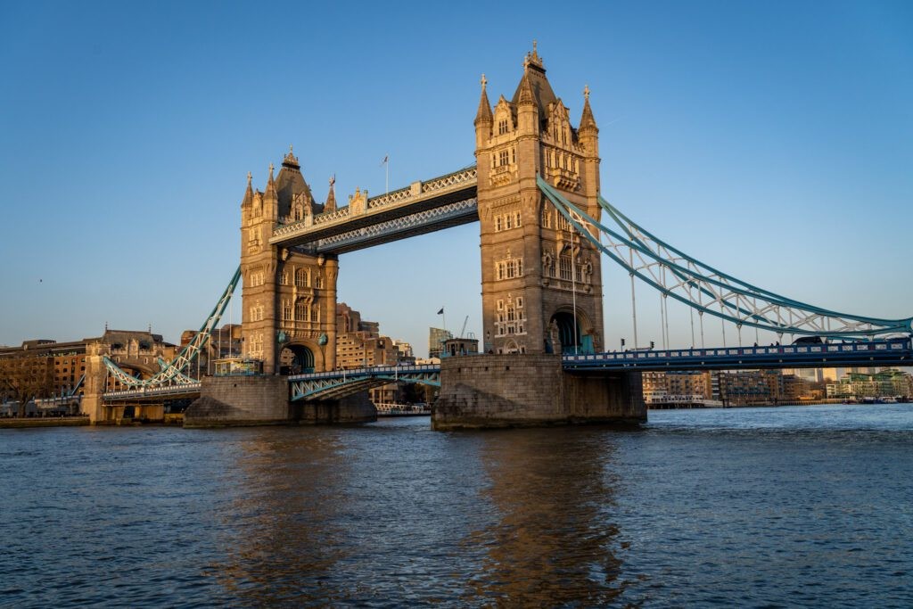 Tower Bridge in London, with its iconic twin towers and raised bascules, as seen from the Tower of London