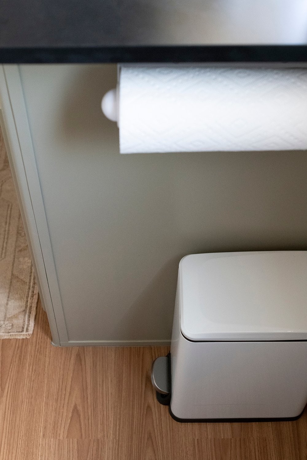 Trash bin and paper towel holder in camper kitchen