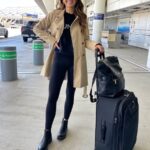 Travel day outfit featuring leggings, trench coat, and Chelsea boots