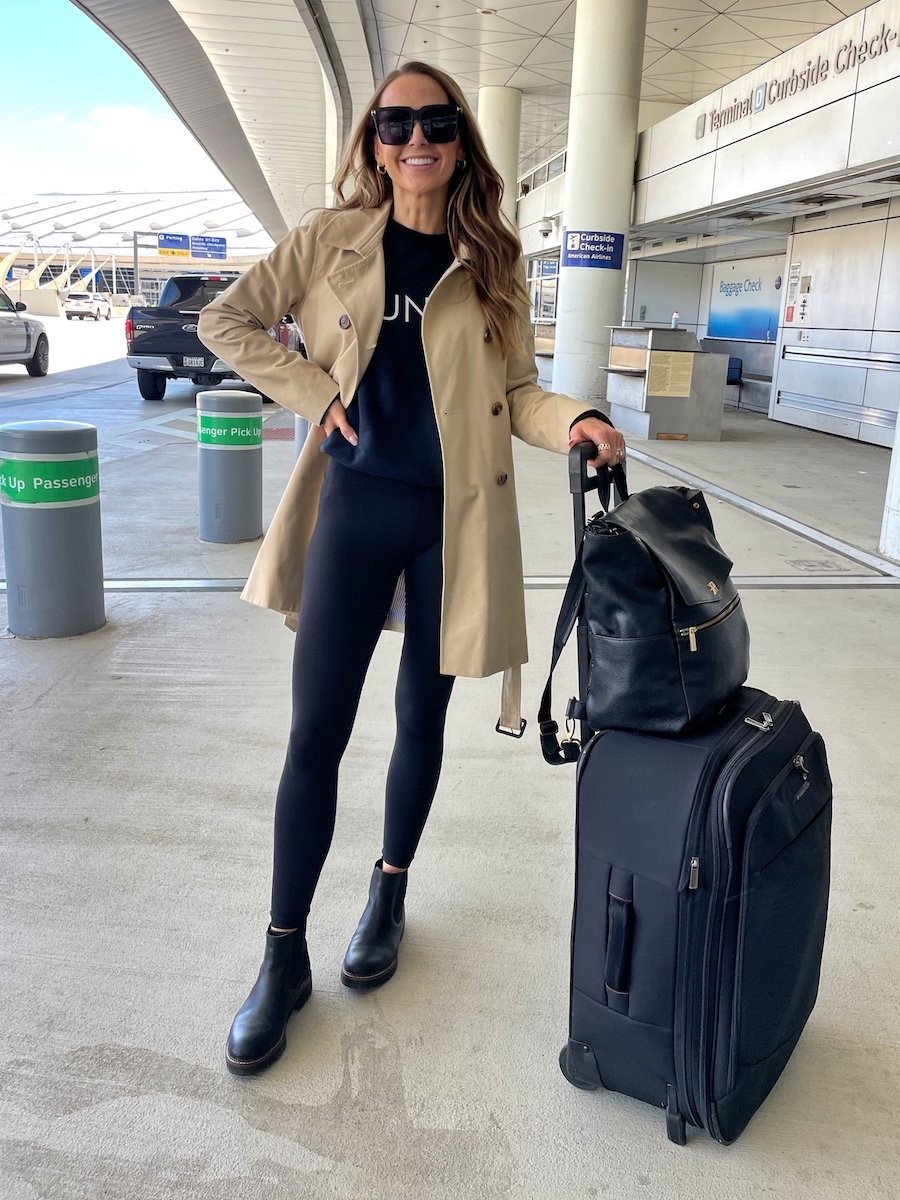 Travel day outfit featuring leggings, trench coat, and Chelsea boots