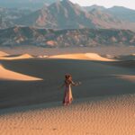 Girl standing in a dress on the Mesquite Flat Sand Dunes