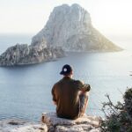 Person enjoying a beach view, representing travel and credit card rewards.