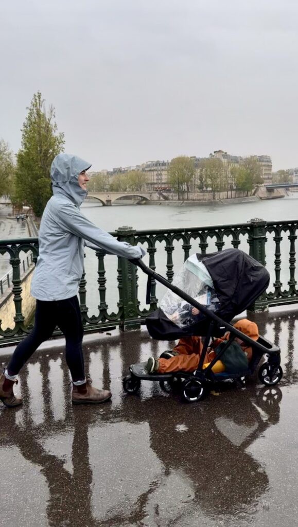 Thule Shine stroller with toddler riding on the rider board, demonstrating its double stroller functionality