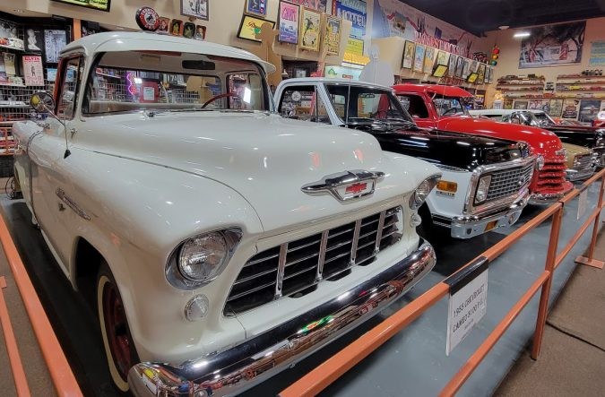 A row of vintage pickup trucks, showcasing different models and eras