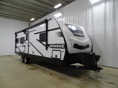 Exterior view of a Winnebago Industries Towables Minnie 2630MLRK travel trailer, showcasing its features and outdoor kitchen.