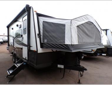 Dinette area inside a Flagstaff Shamrock 183 hybrid travel trailer highlighting the comfortable seating and natural light, available for purchase at Campers Inn RV.