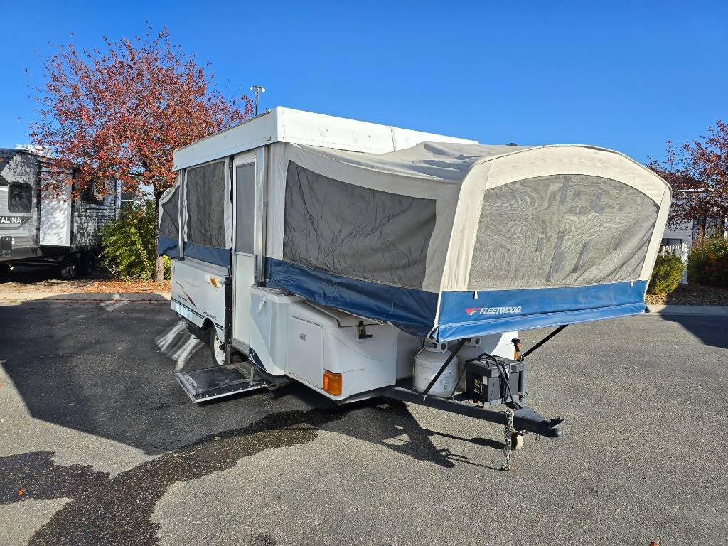 Exterior view of a used 2005 Fleetwood RV Americana Victory pop up camper, showcasing its compact and towable design.