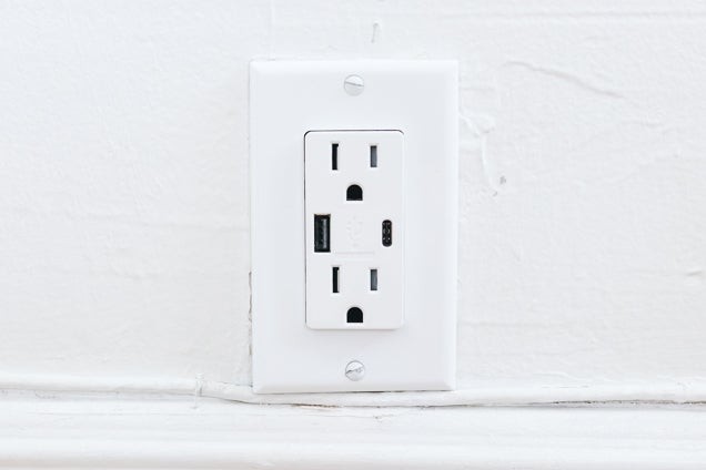 A front look at a wall outlet with two standard plugs in addition to a USB-A and USB-C port, illustrating modern charging options.