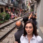 Travel blogger Jordan Gassner smiling in Hanoi Train Street, Vietnam, anticipating the train arrival - Vietnam travel blog 2024