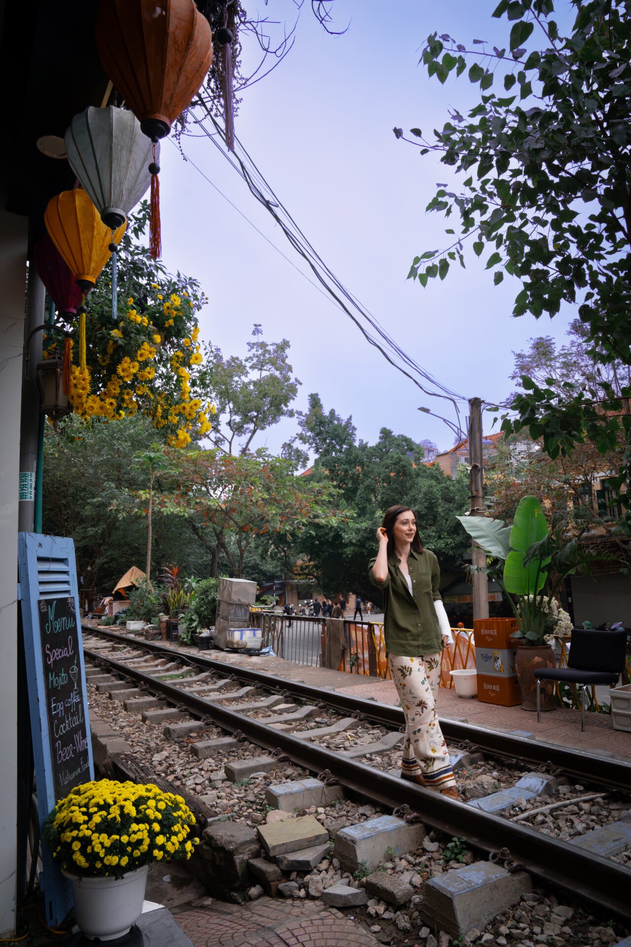 Travel blogger Jordan Gassner on train tracks near Phung Hung Street in Hanoi, Vietnam, capturing the urban scenery of Hanoi - Vietnam travel blog 2024