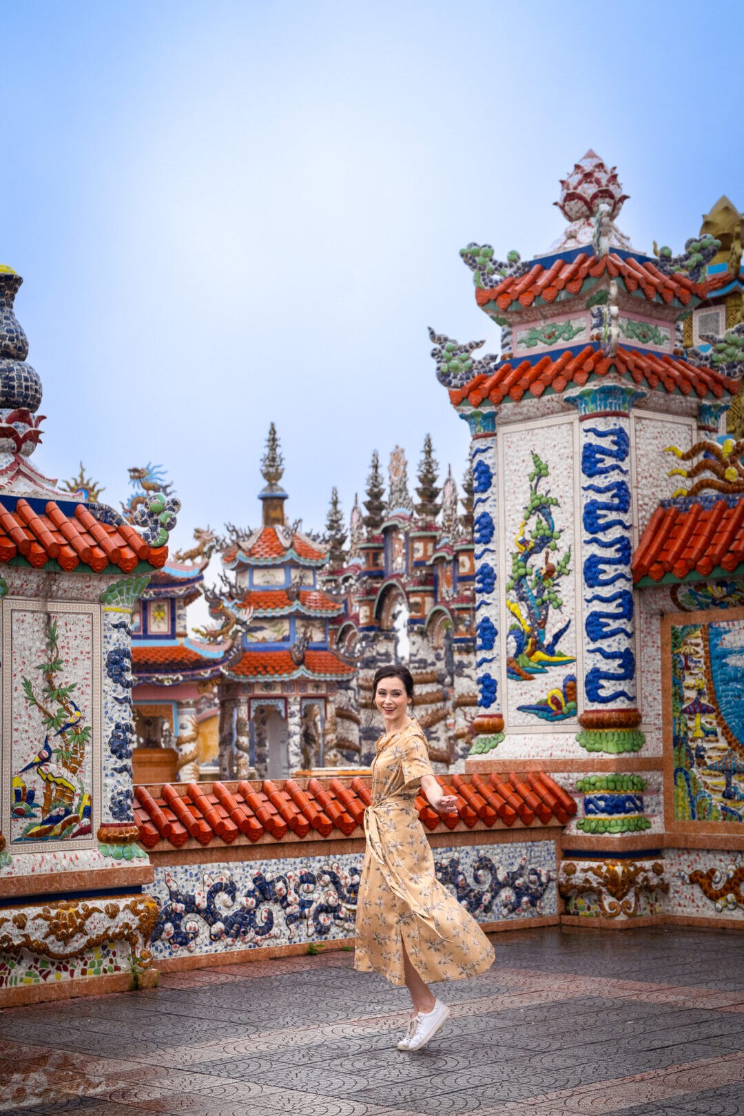 Travel blogger Jordan Gassner playfully twirling at An Bang Cemetery, the City of Ghosts in Hue, Vietnam, exploring unique cultural sites - Vietnam travel blog 2024