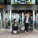 Wheelchair-user and companion leaving the Colorado Springs airport after landing