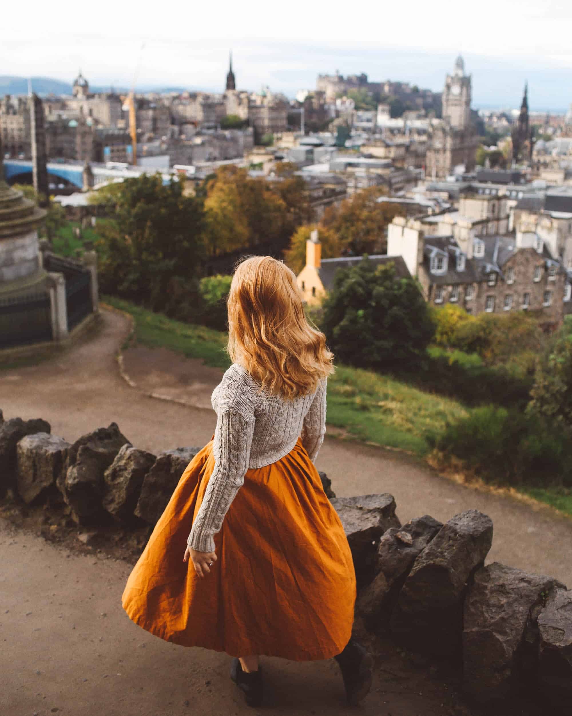 Woman holding a zippered crossbody travel purse in Edinburgh