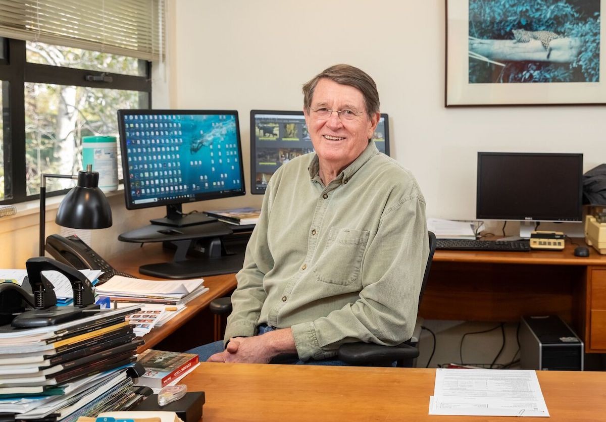 Bill Abbott, the founder of Wilderness Travel, pictured at his Gilman District office in Berkeley, reflecting on decades of pioneering wilderness travel experiences.