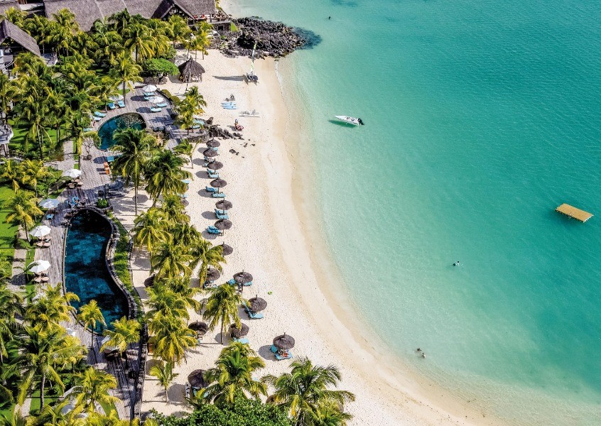 Aerial view of a luxurious resort in Mauritius, showcasing its pristine beaches and crystal-clear waters, inviting guests to indulge in a tropical getaway