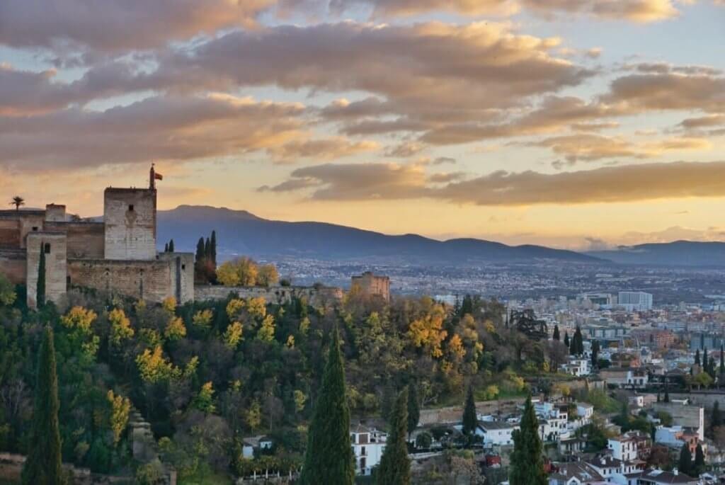 Sunset at the Alhambra lookout point in Granada, Spain