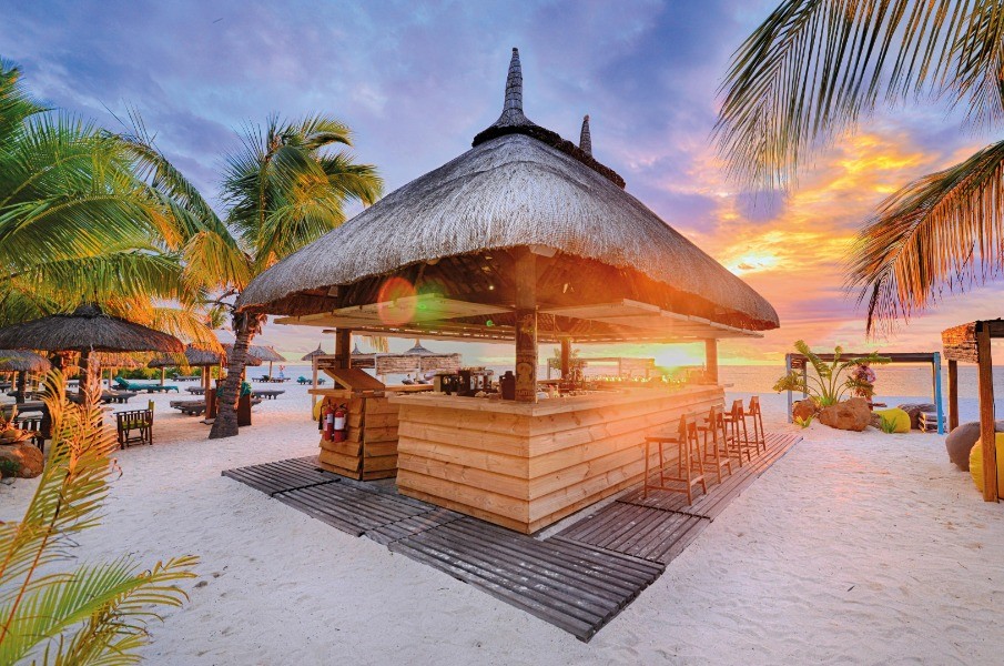 A vibrant beach bar in Mauritius, offering refreshing drinks and a relaxed atmosphere, perfect for enjoying the island's stunning sunsets