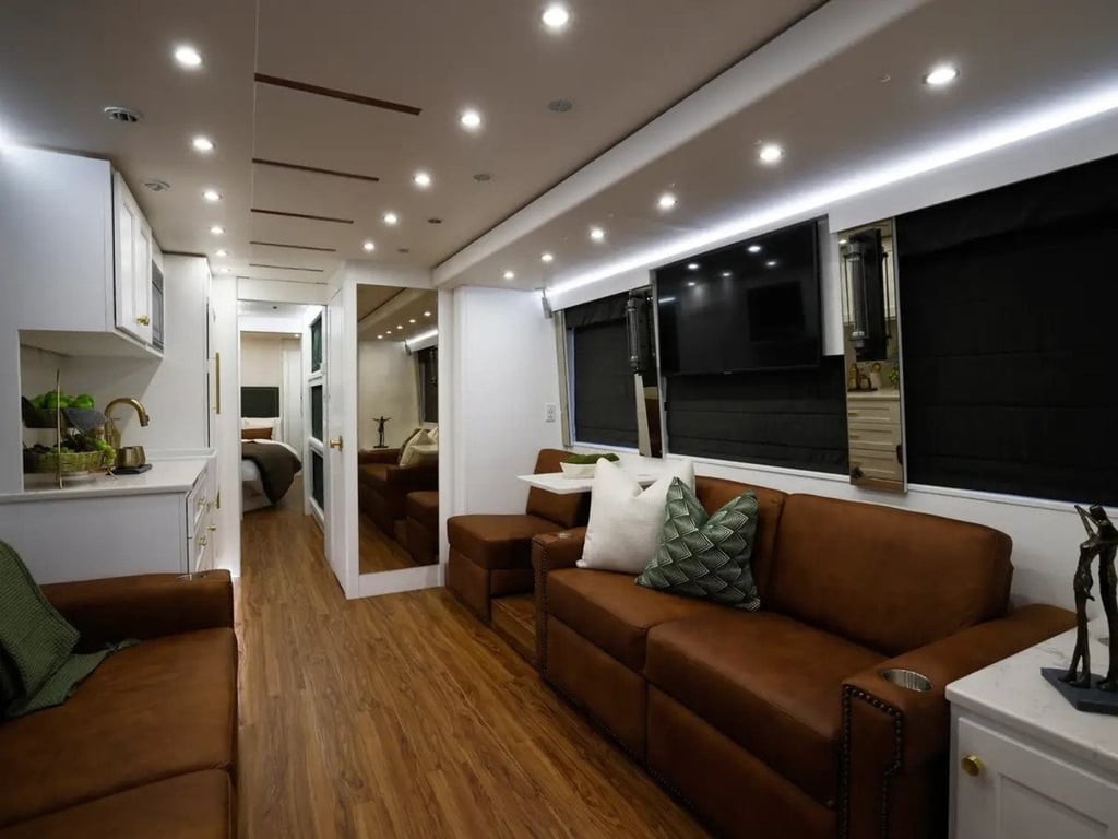 A rendering displays Dreamliner's coach interior, simulating a cozy, residential ambiance. This design enhances the touring experience for artists and their crews, blending performance and comfort.