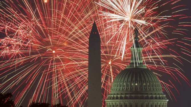 Fireworks explode over the National Mall in DC, illuminating the sky with vibrant colors during the Fourth of July celebrations