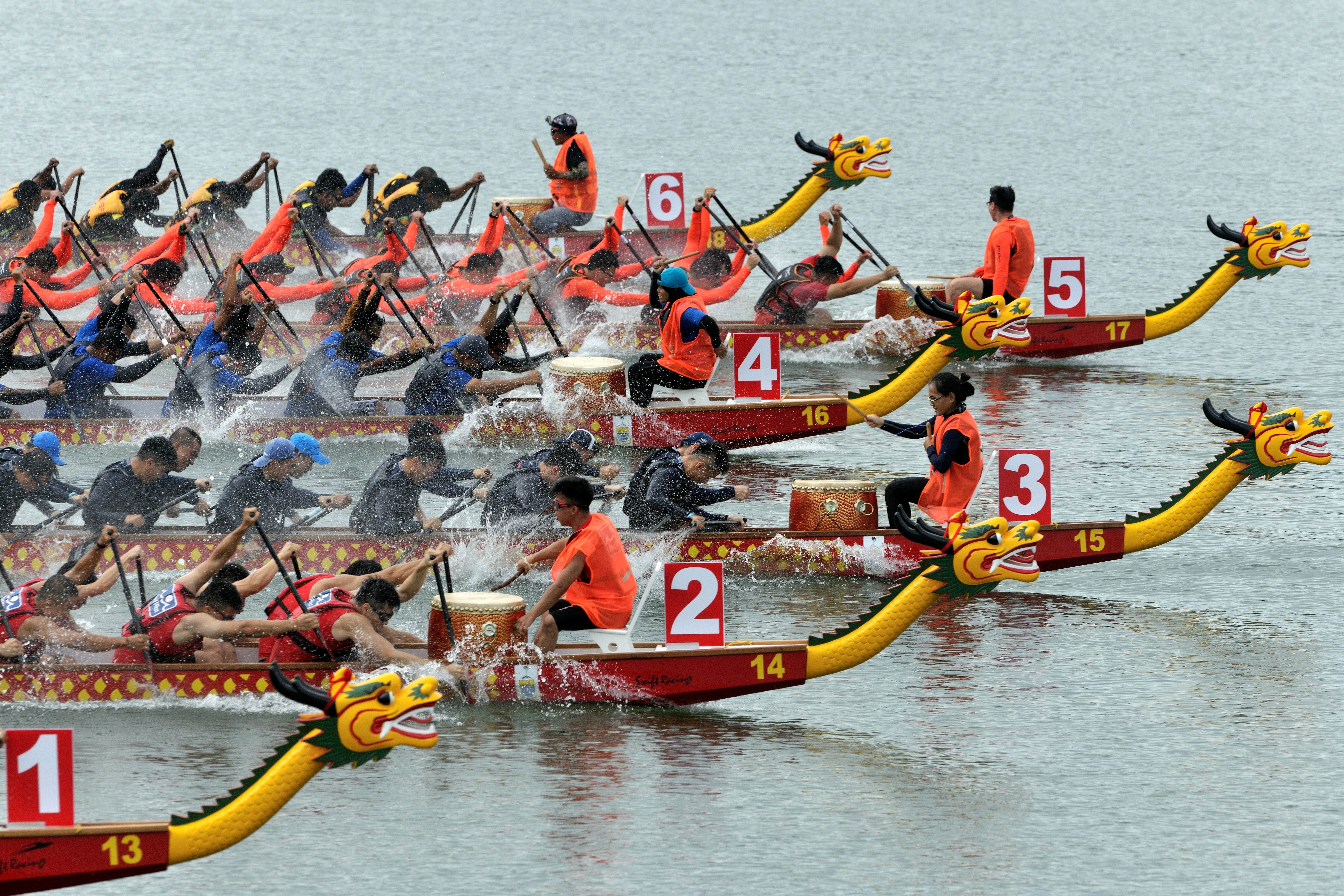 Racers compete at the Penang International Dragon Boat Festival, showcasing vibrant culture