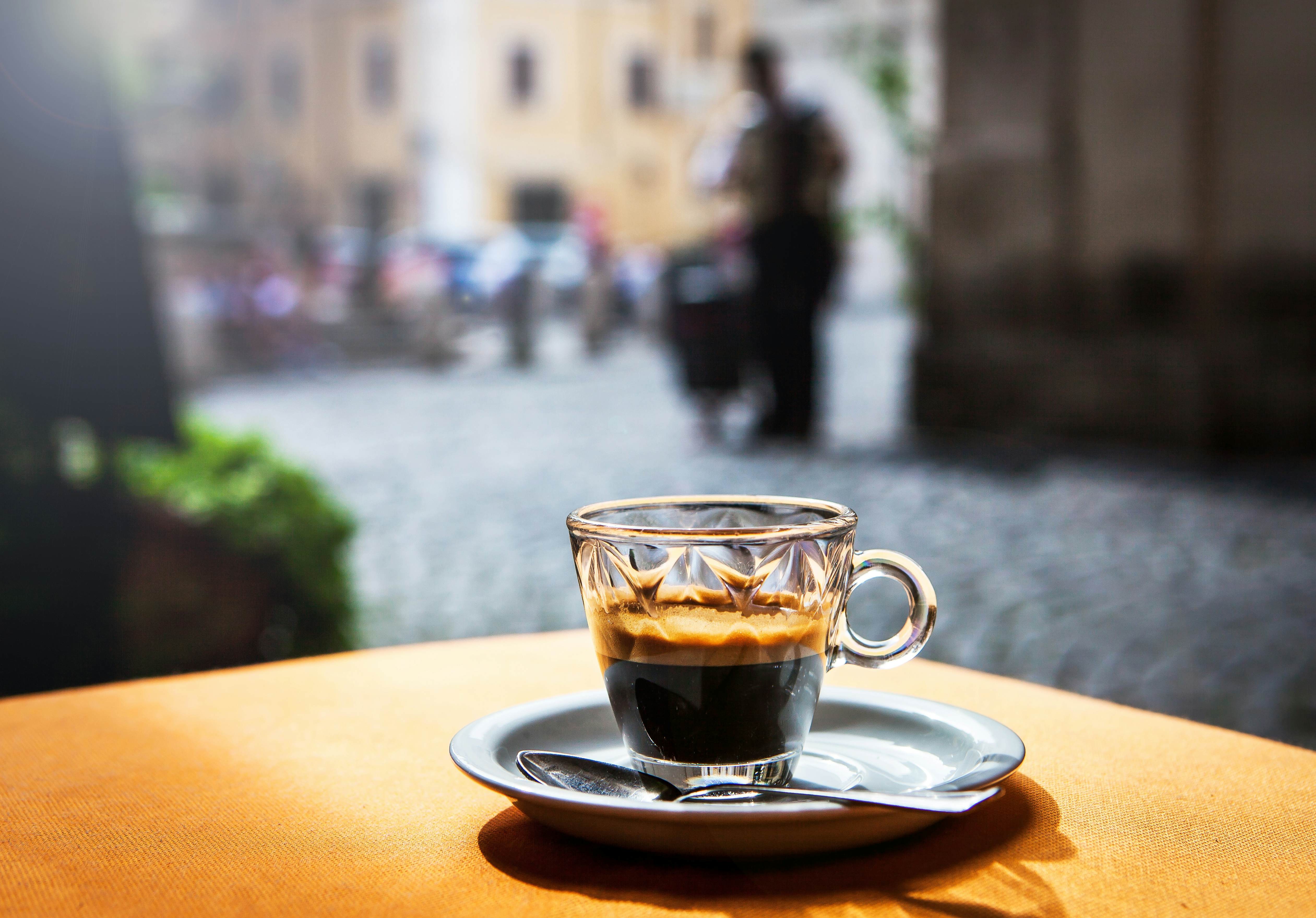 Espresso coffee in a cafe, advising against sitting down for coffee to save money