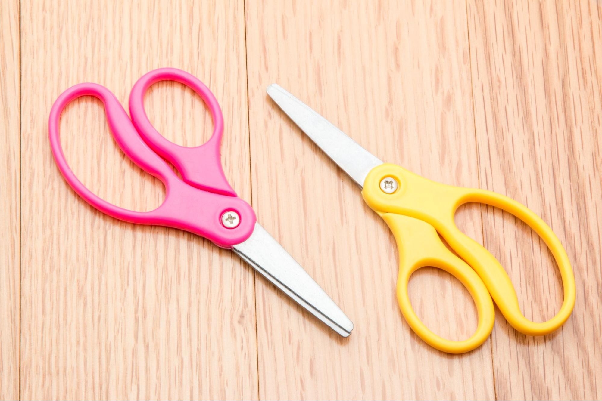 Traveler carefully wrapping scissors with protective material for air travel
