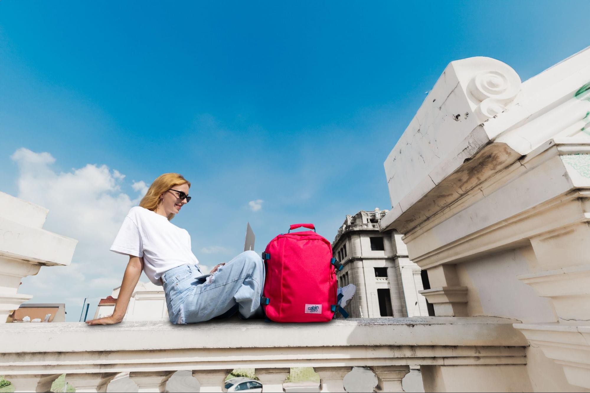 Traveler walking through an airport with a carry-on backpack